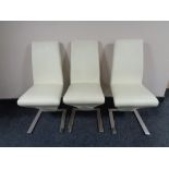 A set of seven cream leather contemporary dining chairs on chrome feet