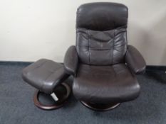 A Stressless brown leather armchair with stool