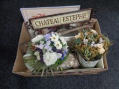A box of artificial flowers, plant trough, contemporary metal signs,