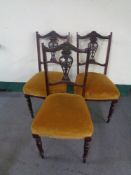 A set of three Edwardian mahogany dining chairs in mustard dralon
