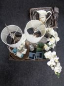 A box of ornaments, lamps with shades, graduated wicker baskets,