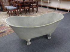 A metal planter in the form of a Victorian roll top bath