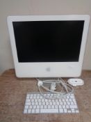 An Apple iMac model ICES-003 Class B with keyboard and mouse