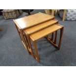 A nest of three mid 20th century teak G Plan tables