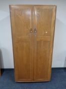 An Ercol solid elm double door hanging wardrobe, catalogue no.