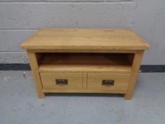 A contemporary oak television stand fitted two drawers
