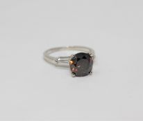 A platinum diamond solitaire ring, the cognac-brown brilliant-cut diamond weighing 3.