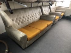 A mid century buttoned vinyl upholstered three piece lounge suite