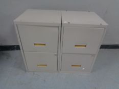 A pair of two drawer metal filing cabinets