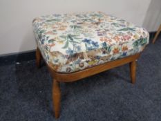 An Ercol solid wood square footstool