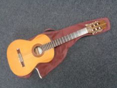 A classical acoustic guitar in carry bag