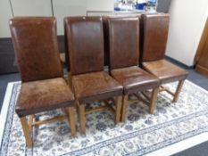 Eight brown leather high backed dining chairs