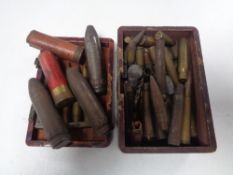 A wooden box containing a quantity of assorted bullet casings,