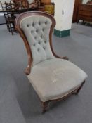 A Victorian mahogany lady's chair upholstered in buttoned fabric