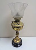 An Edwardian brass oil lamp with glass shade