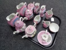 A tray containing antique pink lustre tourist china to include vases, teapots,
