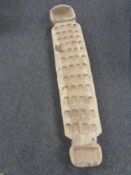 A 20th century African carved board on raised legs