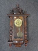 An early 20th century mahogany cased eight day wall clock with pendulum