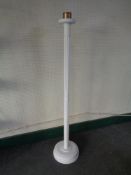 A painted floor standing candle holder