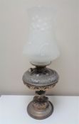A Victorian metal oil lamp with glass shade