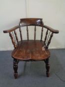 An antique oak captain's armchair