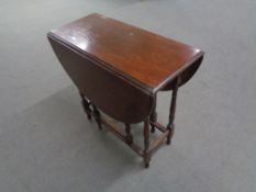 A twentieth century oak gate leg table