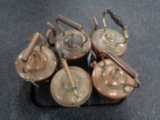 A tray of five antique copper kettles