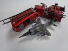 Two tin plate models of fire engines and another of a fighter jet.