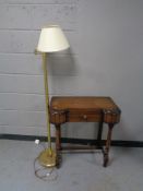 A mid 20th century shaped front hall table and a brass floor lamp with shade