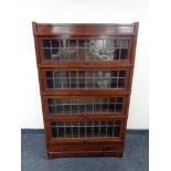 A Globe Wernicke four door leaded glass stacking bookcase fitted drawer beneath