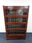 A Globe Wernicke four door leaded glass stacking bookcase fitted drawer beneath