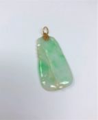 A gold mounted jade pendant CONDITION REPORT: Dimensions are 14.