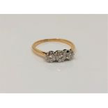 An 18ct gold three stone diamond ring, size M CONDITION REPORT: 2.