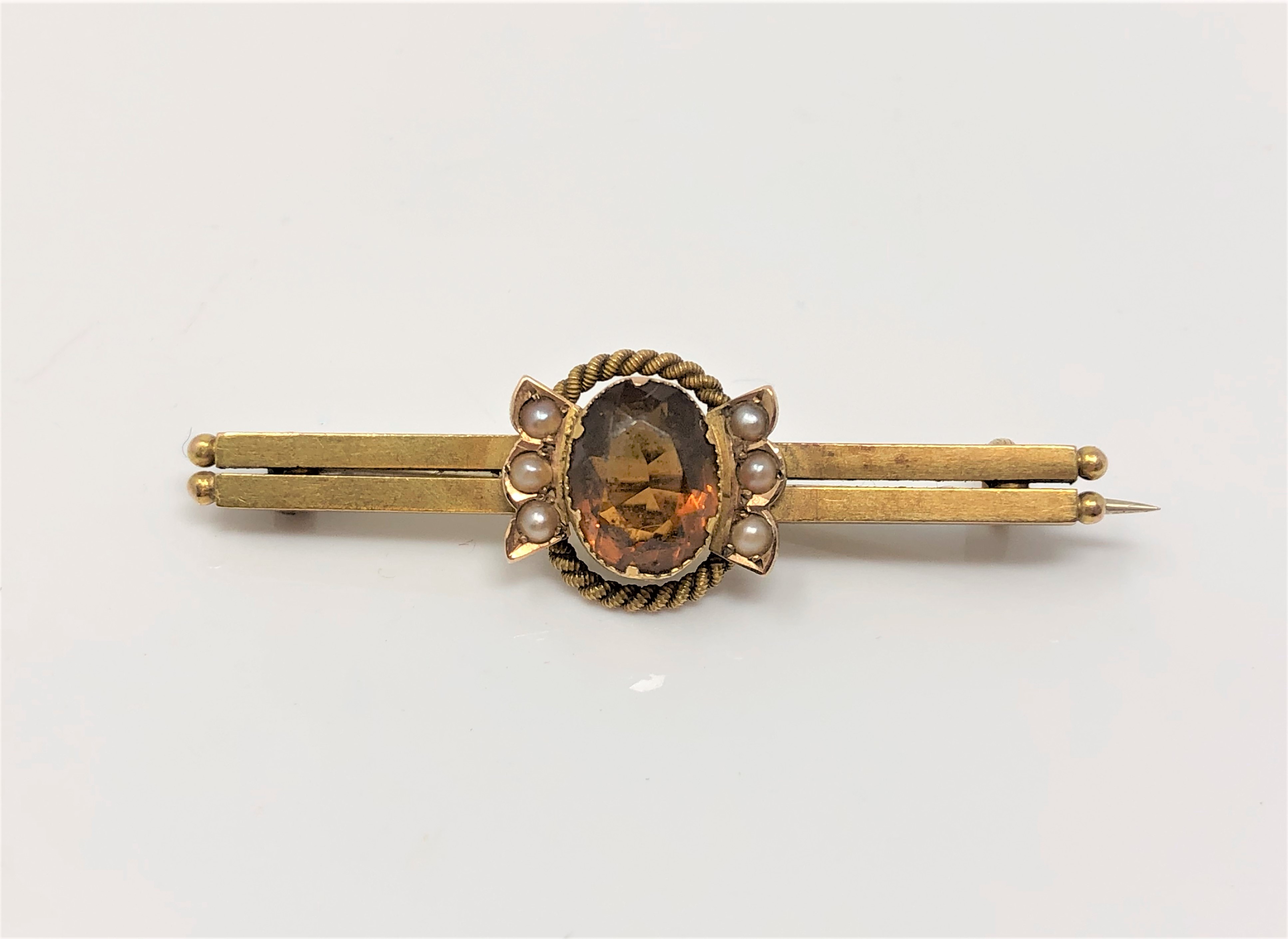 An antique gold citrine and pearl bar brooch CONDITION REPORT: Apparently unmarked.