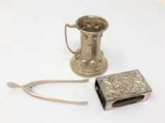 A pair of silver wishbone tongs, a silver matchbox case and a silver miniature Scandinavian tankard,