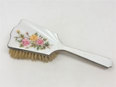 A silver and floral enamel dressing table brush