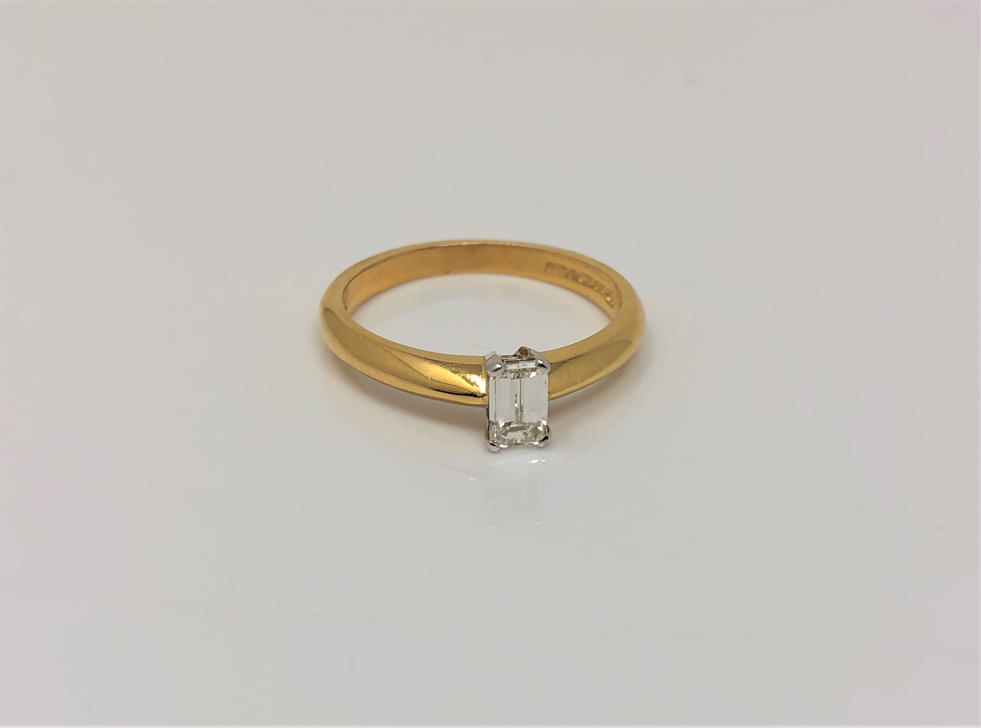 An 18ct gold emerald cut diamond solitaire ring, approx. 0.