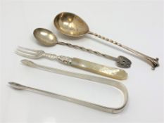 A group of silver cutlery including pair of Georgian tongs,