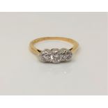 An 18ct gold and platinum three stone diamond ring, centre stone approx. 0.