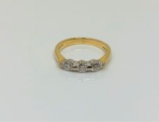 An 18ct gold three stone diamond ring, size K1/2 CONDITION REPORT: 3.