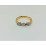 An 18ct gold three stone diamond ring, size K1/2 CONDITION REPORT: 3.