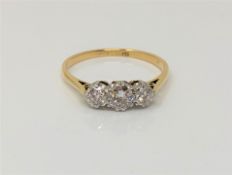 An 18ct gold three stone diamond ring, size P CONDITION REPORT: 2.