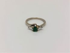 An 18ct gold emerald and diamond ring,