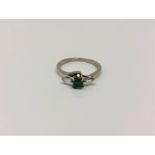 An 18ct gold emerald and diamond ring,