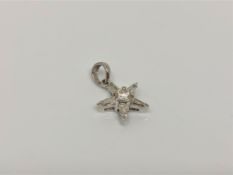An 18ct white gold diamond star pendant set with central brilliant cut diamond and five baguette