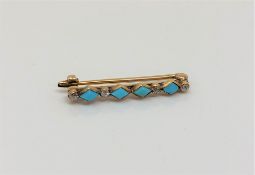 A gold turquoise and diamond brooch, length 26mm CONDITION REPORT: 1.