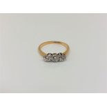 An 18ct gold and platinum three stone diamond ring, approx. 0.