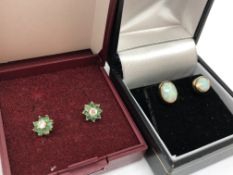 A pair of gold opal earrings and a pair of emerald and diamond earrings