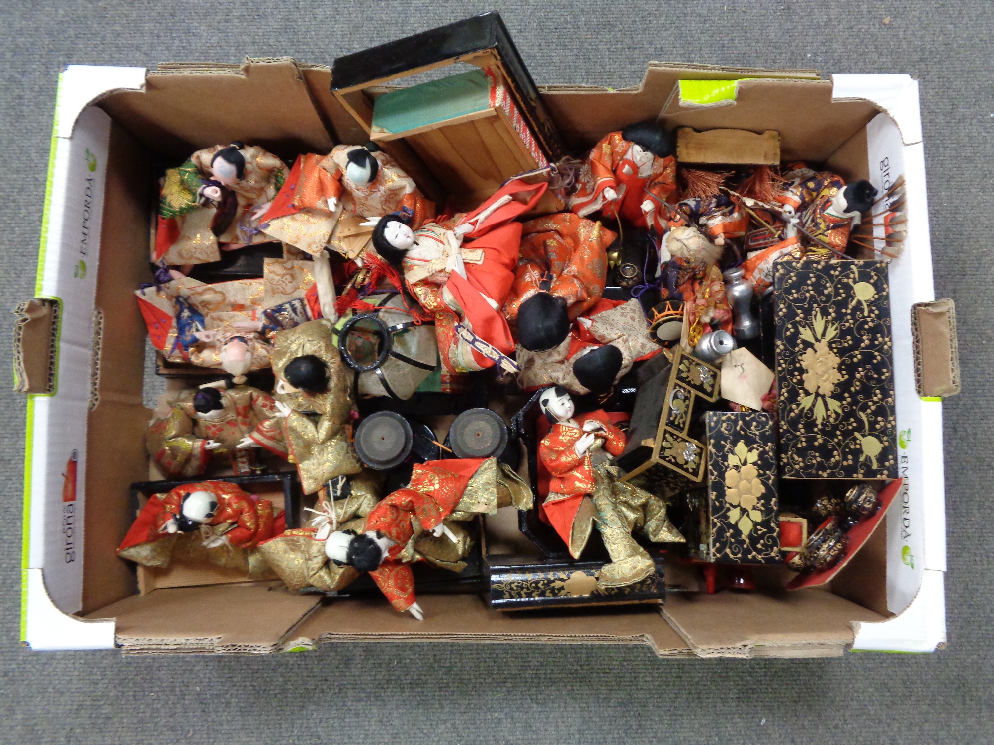 A box containing Japanese hand painted wooden headed dolls and furniture