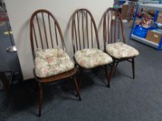 A set of three ercol solid beech high back dining chairs in an antique finish